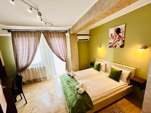 a bedroom with a bed and a large window at Style Residence in Sibiu