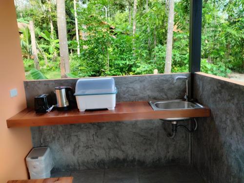 a kitchen counter with a sink and a window at Zabit Bungalow in Ko Lanta