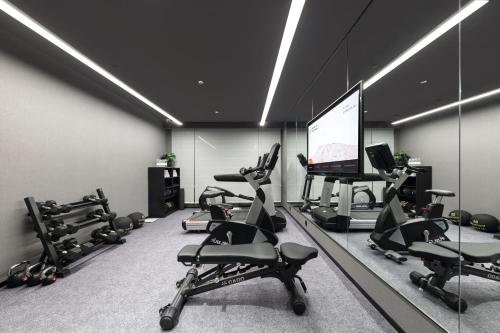 a gym with several exercise bikes and a flat screen tv at Atour Hotel Hangzhou Xiaoshan Kaiyuan Plaza in Xiaoshan
