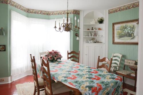 a dining room with a table with a floral table cloth at 5449 Emerald home in Dewittville