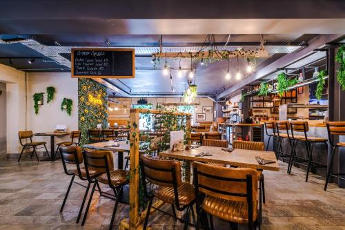 a restaurant with tables and chairs and a bar at No.6 - Studio Apartment with Private Terrace in Stoney Middleton