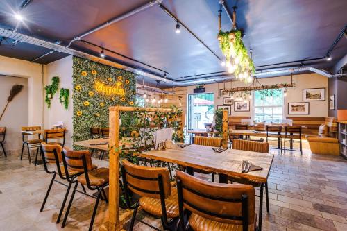 a restaurant with tables and chairs in a room at No.6 - Studio Apartment with Private Terrace in Stoney Middleton