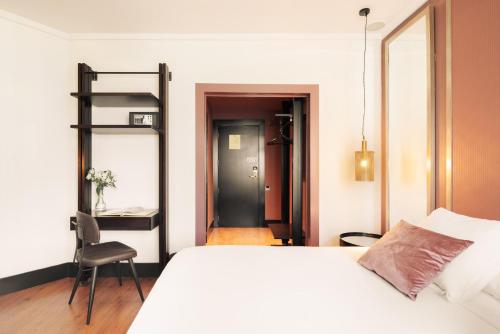 a bedroom with a bed and a ladder and a chair at La França Travellers Adults Only in Barcelona