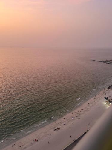 an aerial view of a beach with a group of people at Sunset Beach View Holiday Homes in Ajman 