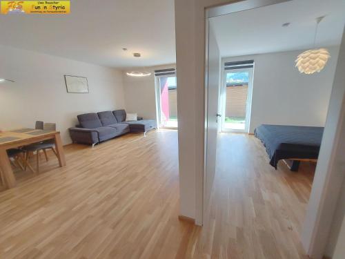 a living room with a blue couch and a table at Apartment Bergzeit in Öblarn