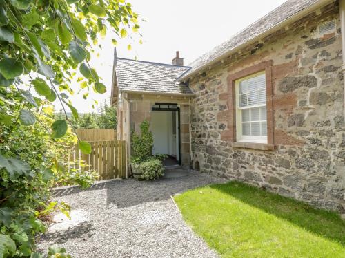 a brick house with a door and a yard at North Firbank - Culzean Castle in Maybole