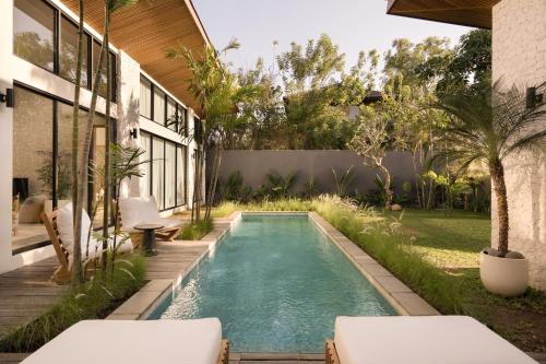 an infinity pool in the backyard of a house at Villa Zara Spacious, Chic and Classy 2 Bedroom Home 5 minutes from Uluwatu Cliff Edge in Uluwatu