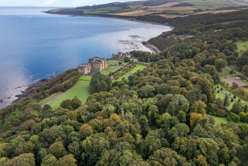 an aerial view of a castle on a island in the water at Garden House - Culzean Castle in Maybole