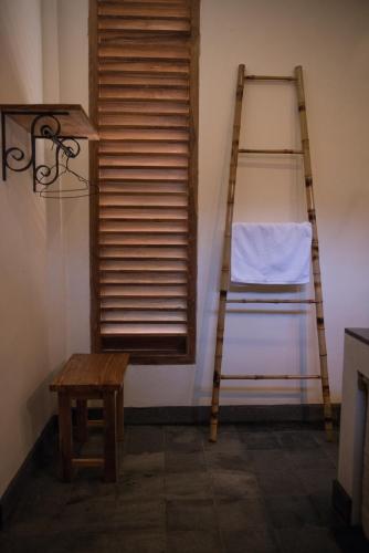 a ladder and a stool in a room with a window at Blue Garden Yogyakarta in Yogyakarta