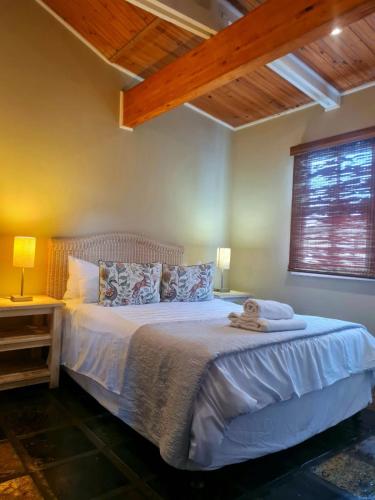 a bedroom with a bed with a teddy bear on it at Point Village Accommodation -Linky's House in Mossel Bay