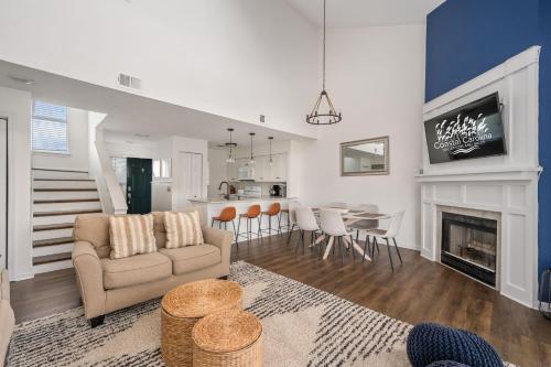 a living room with a couch and a dining room at PCBV325 Anchor's Away in Manteo