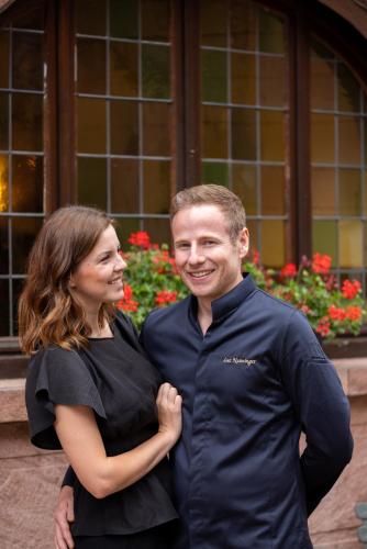 a man and a woman posing for a picture at L'Auberge du Brand in Turckheim