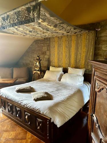 Postel nebo postele na pokoji v ubytování Hôtel le Manoir du Soldat