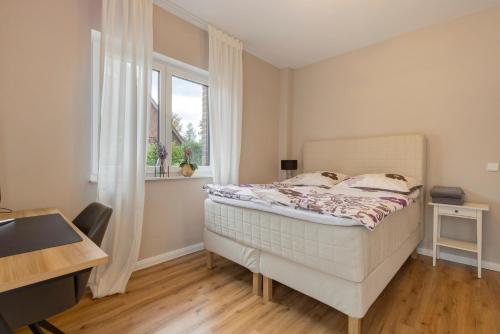 a bedroom with a bed and a window at Luxurious Family House in Tornesch