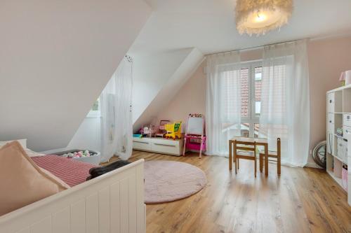 a bedroom with a bed and a table with a chair at Luxurious Family House in Tornesch