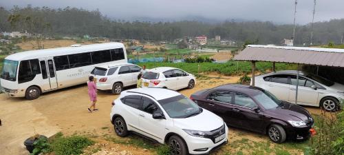 a group of cars parked next to a bus at SHADOW MASK BUNGALOW in Pattipola