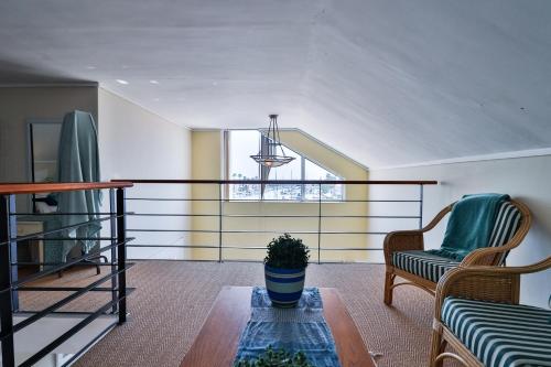a living room with a table and a chair at Harbour Lights in Velddrif