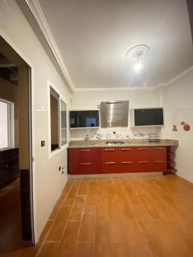 a large kitchen with a wooden floor in a room at Charming app 3 min Sania Ramel AIRPORT Tetuan in Tetouan