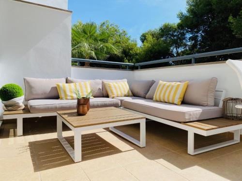 a couch and a table on a patio at Aire del mediterráneo- Garrucha in Garrucha