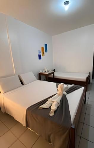 a bedroom with a bed with a robe on it at Pousada Ventos do Mar in Natal