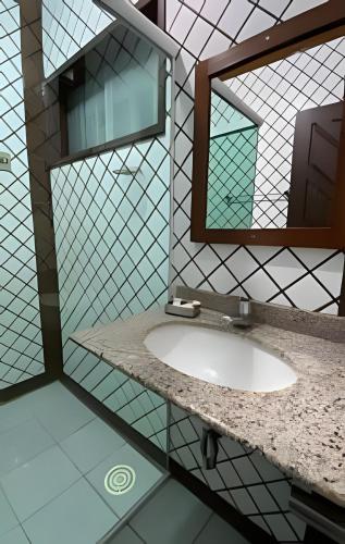 a bathroom with a sink and a mirror at Pousada Ventos do Mar in Natal