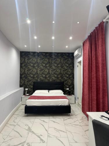 a bedroom with a bed and a red curtain at luxury 2.0 in Naples