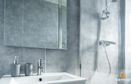 a bathroom with a sink and a shower at Sandeman by CENTRAL SERVICED APARTMENTS - 2 Bedroom - FREE Street Parking - Fast WiFi - Smart TVs in All Rooms - Ground Level - Family Neighbourhood - 3 x Double Beds - Heating 24-7 - Trade Stays - Weekly & Monthly Offers in Dundee