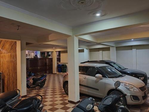 a garage with a car and motorcycles in it at Mild Life Hostel Rishikesh in Rishīkesh