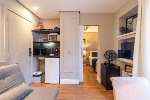 a living room with a refrigerator and a kitchen at LFlats no Hotel Stella Vega (EX-Mercury Ibirapuera) in Sao Paulo