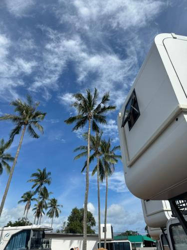 a white camper with palm trees in the background at Space House Hotel Phuket in Rawai Beach