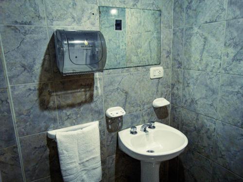 a bathroom with a sink and a mirror at Constantino Hostel by lo de Guille in El Chalten