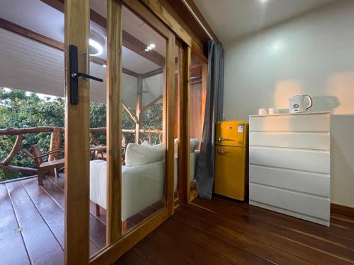 a room with a bed and a sliding glass door at Tantawan sea view residence 山海居 in Salad Beach