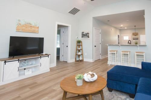 a living room with a blue couch and a table at Dorothy in Gulfport