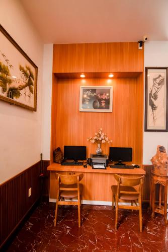 a office with a desk with two computers on it at Minh Hiếu Hotel in Hue