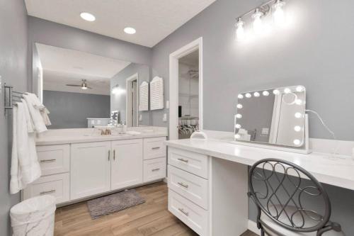 a white bathroom with a sink and a mirror at Peaceful Waters Your Intimate Hot Tub Escape in Houston