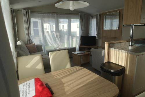 a small living room with a table and a living room at Red Lion Holiday Park in Arbroath