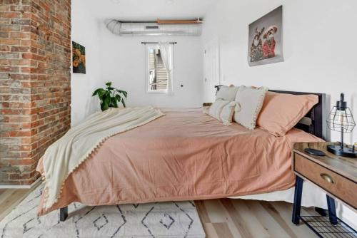 a bedroom with a large bed and a brick wall at Tasteful Full Home Dtown Buffalo in Buffalo