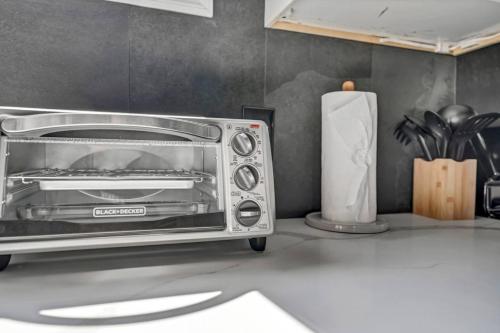 a toaster oven sitting on top of a kitchen counter at Tasteful Full Home Dtown Buffalo in Buffalo