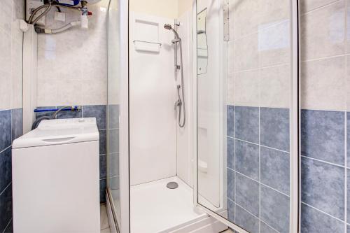 une douche avec une porte vitrée dans une salle de bain dans l'établissement Mirande 1 - Appt vue mer et montagne, à Port-Vendres