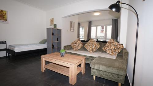 a living room with a couch and a table at Consci apartments in Antwerp