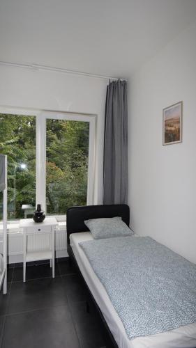 a bedroom with a bed and a window at Consci apartments in Antwerp