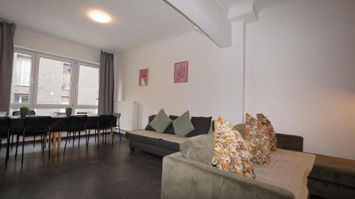 a living room with a couch and a dining room at Consci apartments in Antwerp