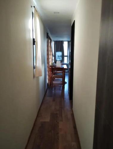 a hallway with a table and a desk in a room at Cabañas en Koslay Ñalala Ivoqué con piscina climatizada en épocas cálidas in Juana Koslay 