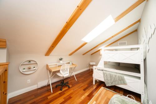 a bedroom with a loft bed and a desk at MuskokaWaterfront PoolTable 98TV 6Acres in Huntsville