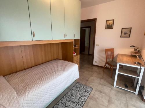 a bedroom with a bed and a desk and a table at Villa Green Harmony in Bussolengo
