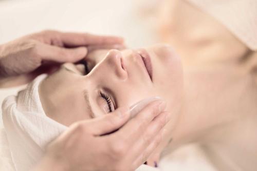 a woman getting her face groomed by a beautician at Hotel Lindenwirt in Drachselsried