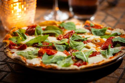 a pizza on a plate on a table at Transamerica Comandatuba - All Inclusive Resort in Ilha de Comandatuba