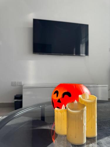 a pumpkin sitting on top of a glass table at Cozy 1BR Pool-Gym, close to metro BrandNew! in Dubai