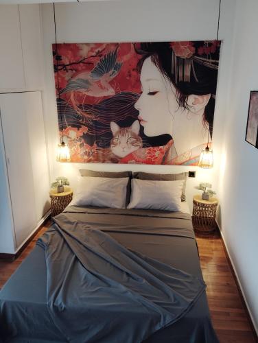 a bed with a cat sitting on top of it at Tiny Japan in Volos