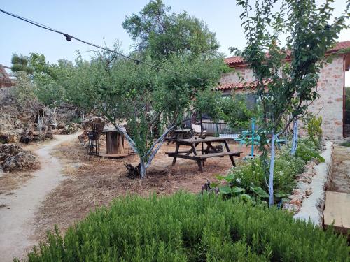 a picnic table in a garden next to a building at 3 Oda Kaş in Kas